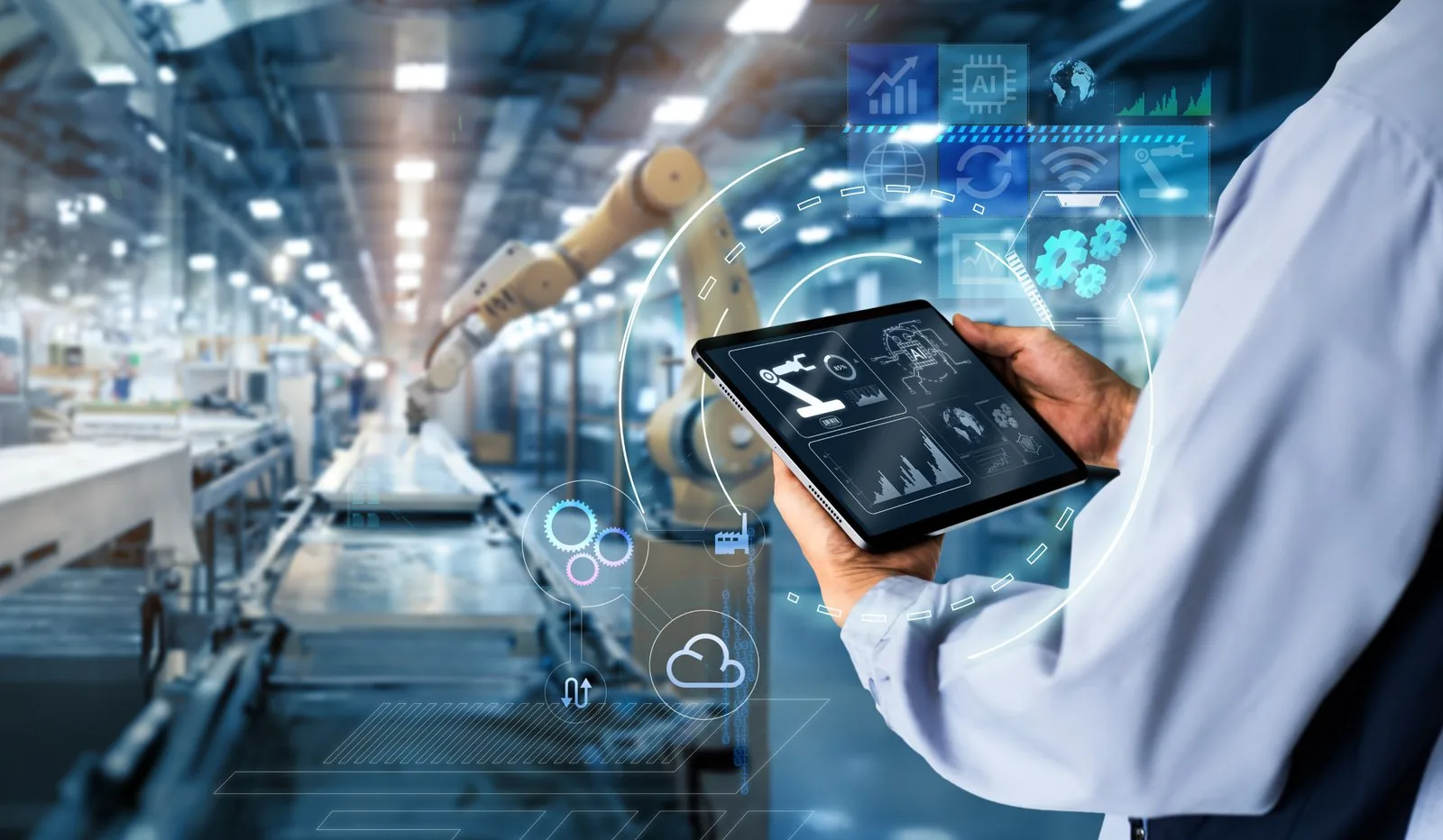 Person mit Tablet in einer Fertigungshalle mit Industrierobotern